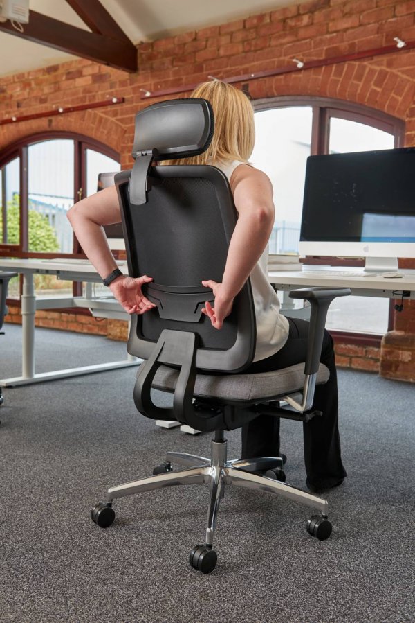 Woman Adjusting Integral Lumbar Support on Chair