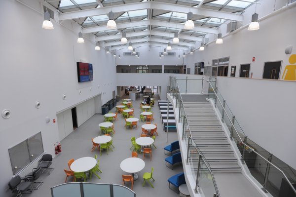 Orange-Green-Plastic-Postura-Plus-Chairs-In-Atrium-Area